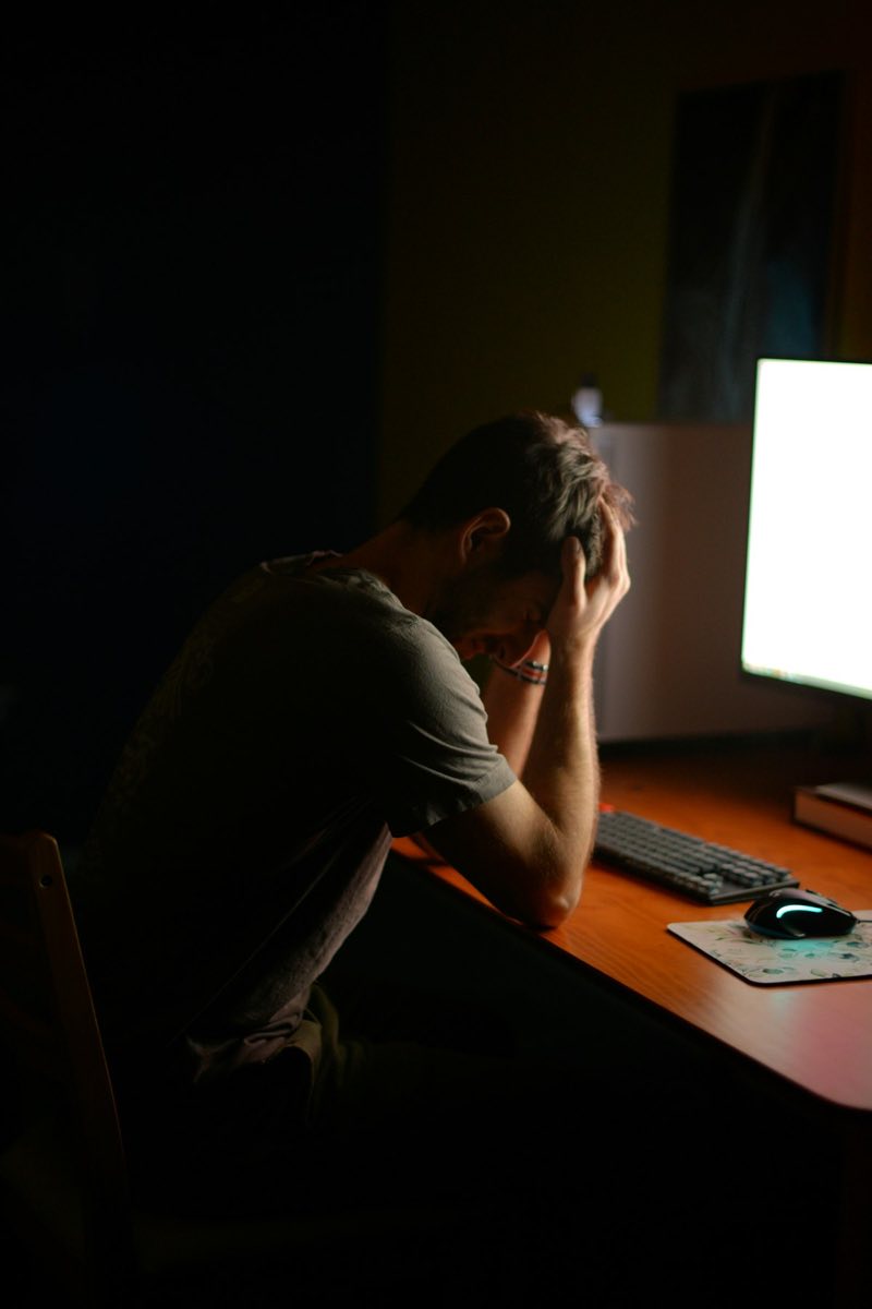 Person slumped at computer desk